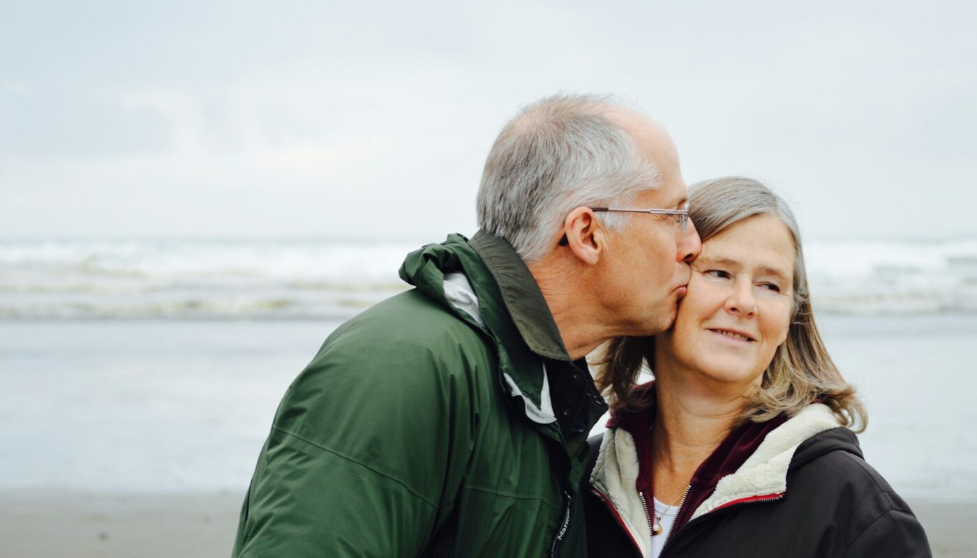 Older couple sharing a moment by the sea (photo: Esther Ann / Unsplash)