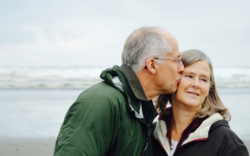 Older couple sharing a moment by the sea (photo: Esther Ann / Unsplash)