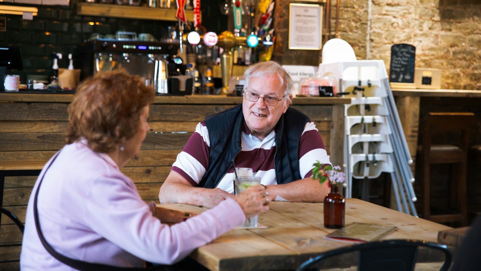 Couple chatting over drinks in a cafe (photo: Centre for Ageing Better / Unsplash)
