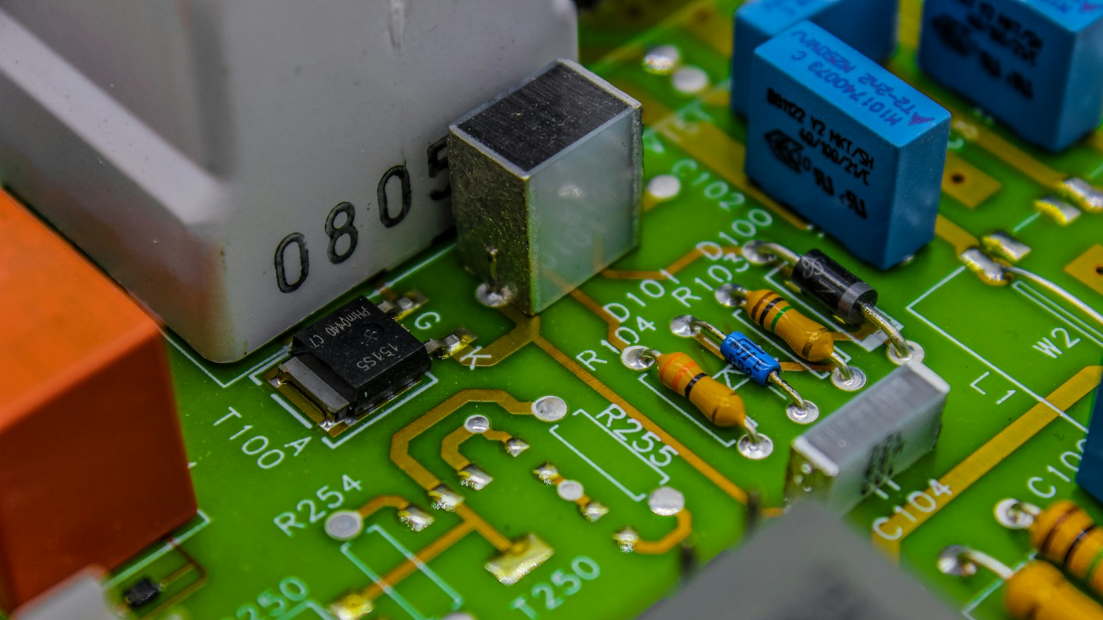 Electronic components soldered onto a green circuit board (photo: Bermix Studio / Unsplash)