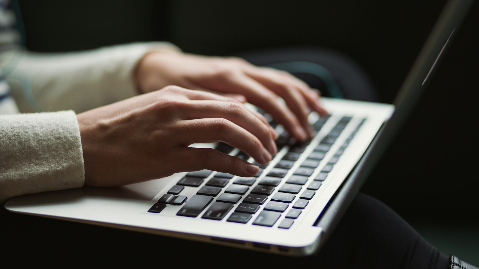 Hands typing on a laptop keyboard (photo: Kaitlyn Baker / Unsplash)
