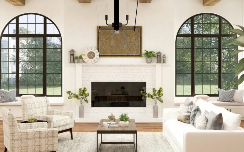 Bright living room with arched windows, exposed wood beams and a white brick fireplace