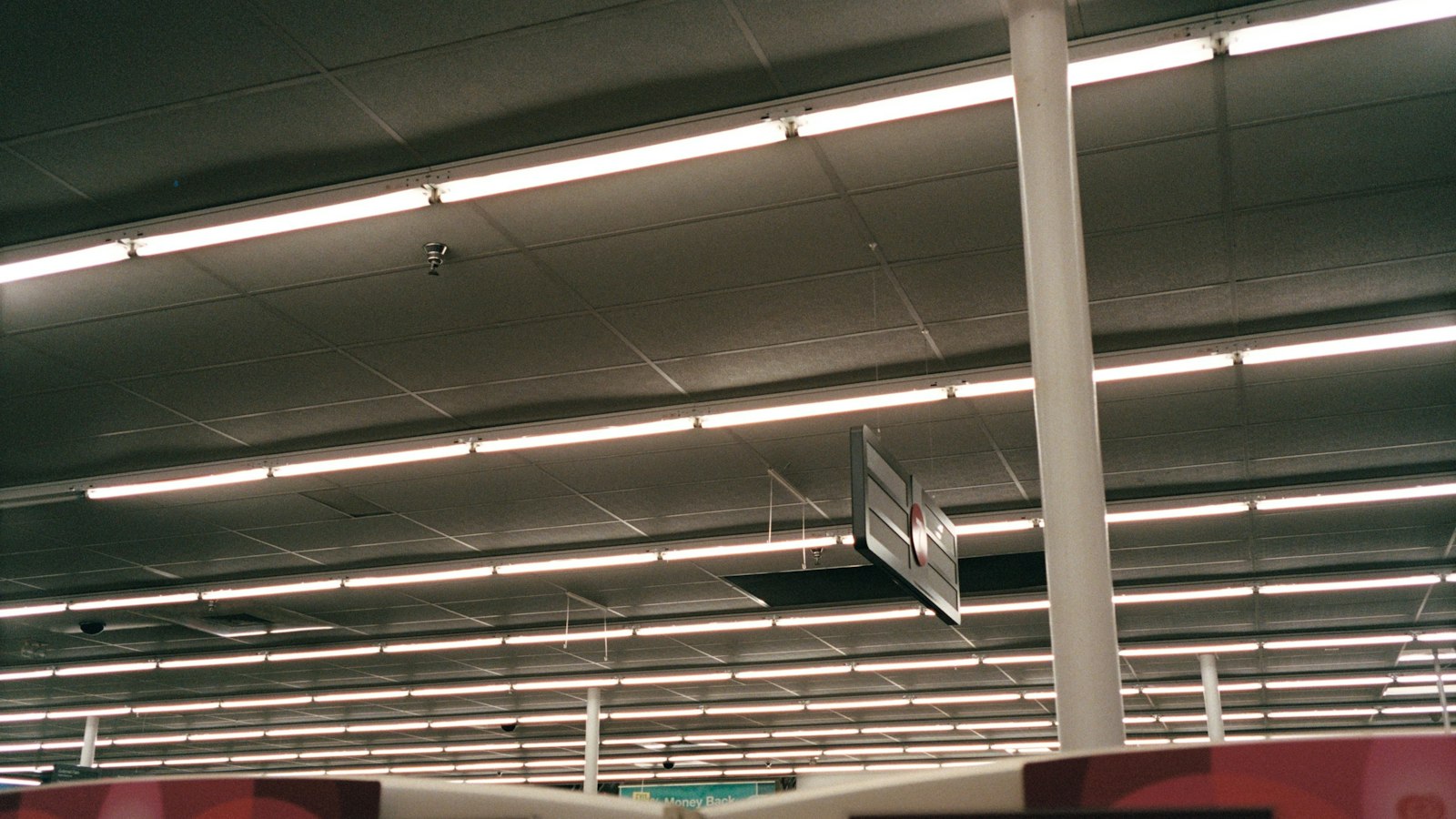 Bright aisle inside a large drugstore (photo: Jason Zeis / Unsplash)