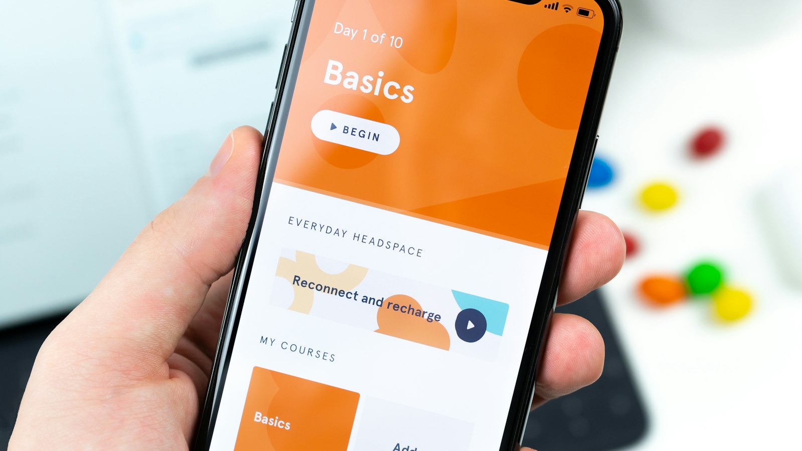 Hand holding a phone with a shopping app open (photo: Daniel Korpai / Unsplash)