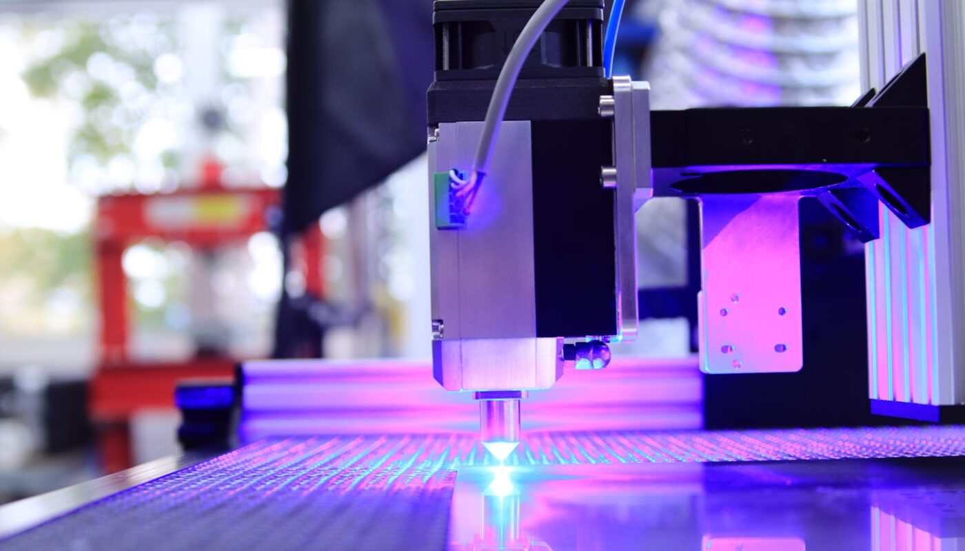 The violet glow of a diode laser cutting head at work (photo: Opt Lasers / Unsplash)