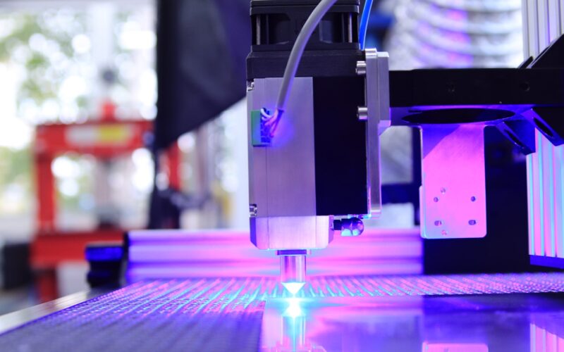 The violet glow of a diode laser cutting head at work (photo: Opt Lasers / Unsplash)