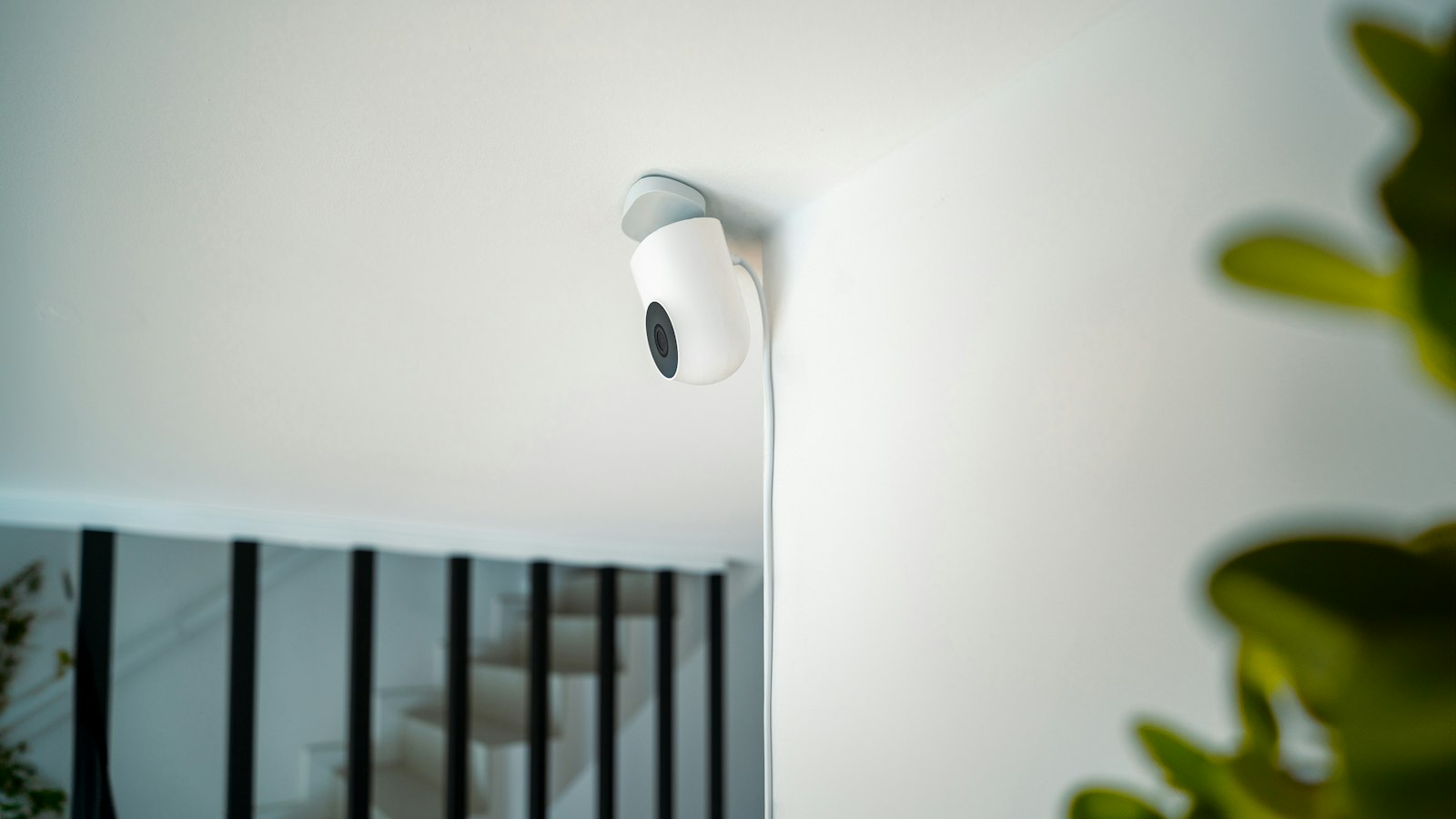 Small indoor security camera mounted on a wall (photo: Jakub Żerdzicki / Unsplash)