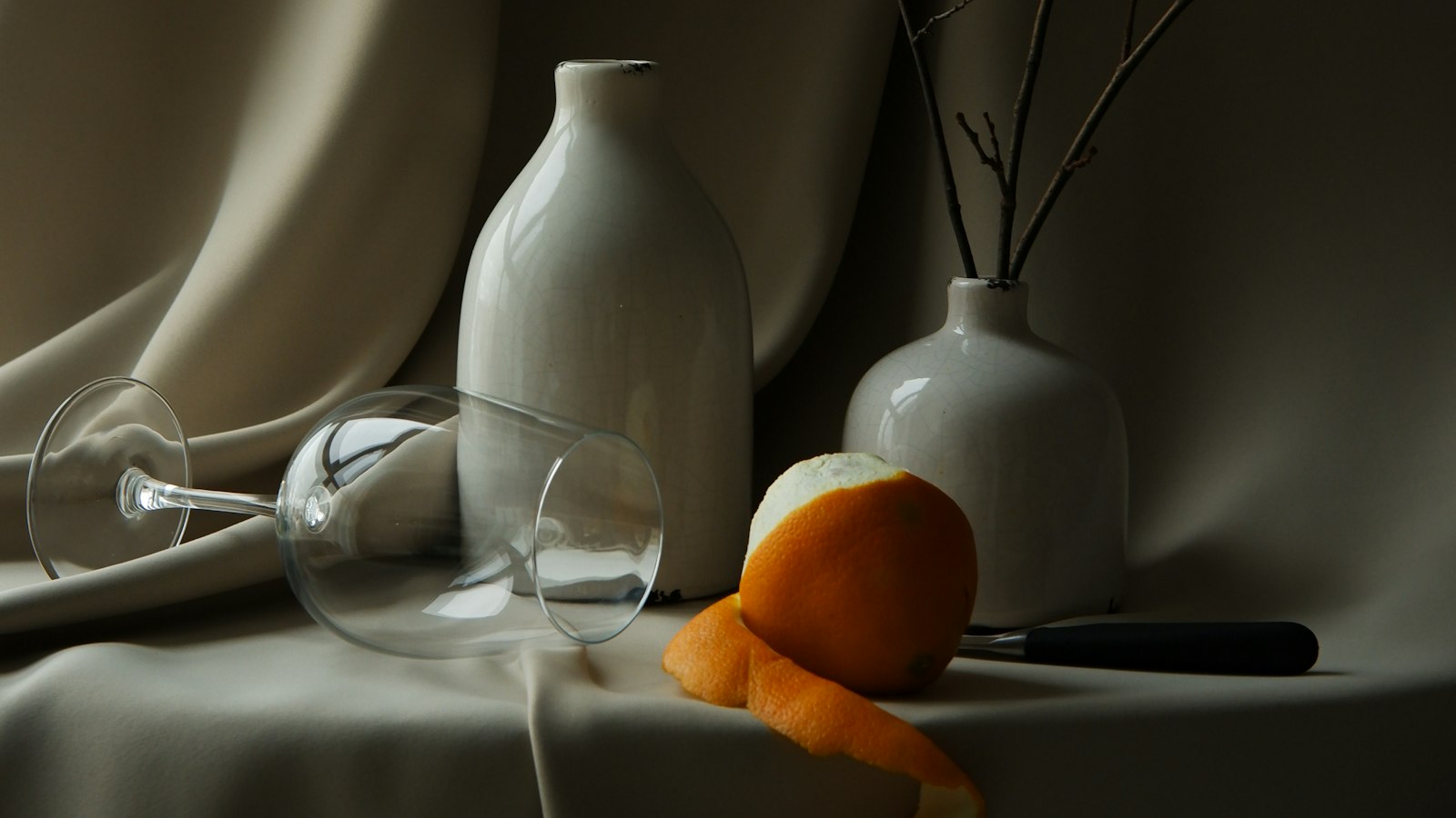 Ceramic vases in soft light against a draped curtain (photo: Mary Skrynnikova / Unsplash)