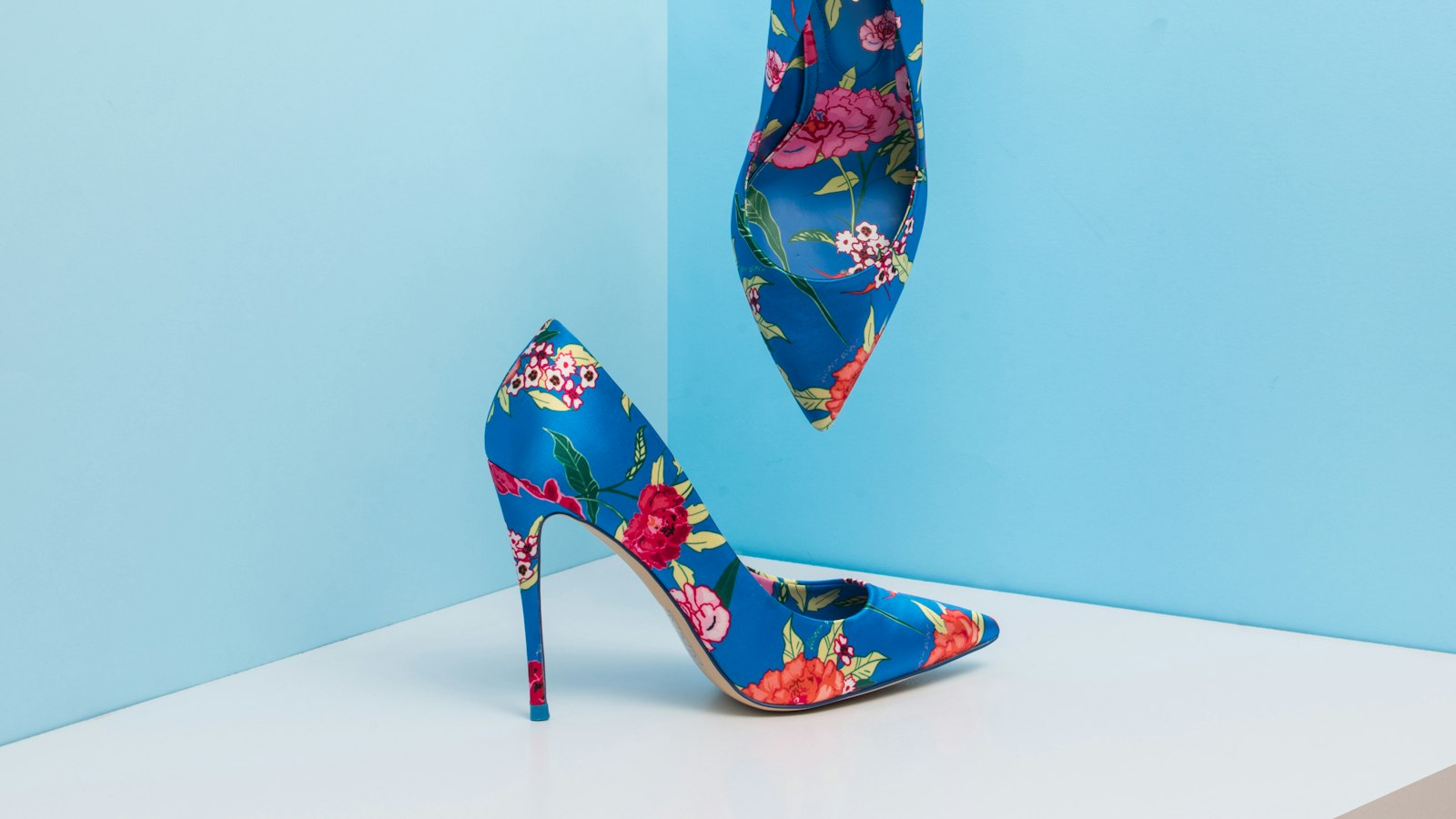 Floral print stiletto heels against a pale blue wall (photo: Mohammad Metri / Unsplash)