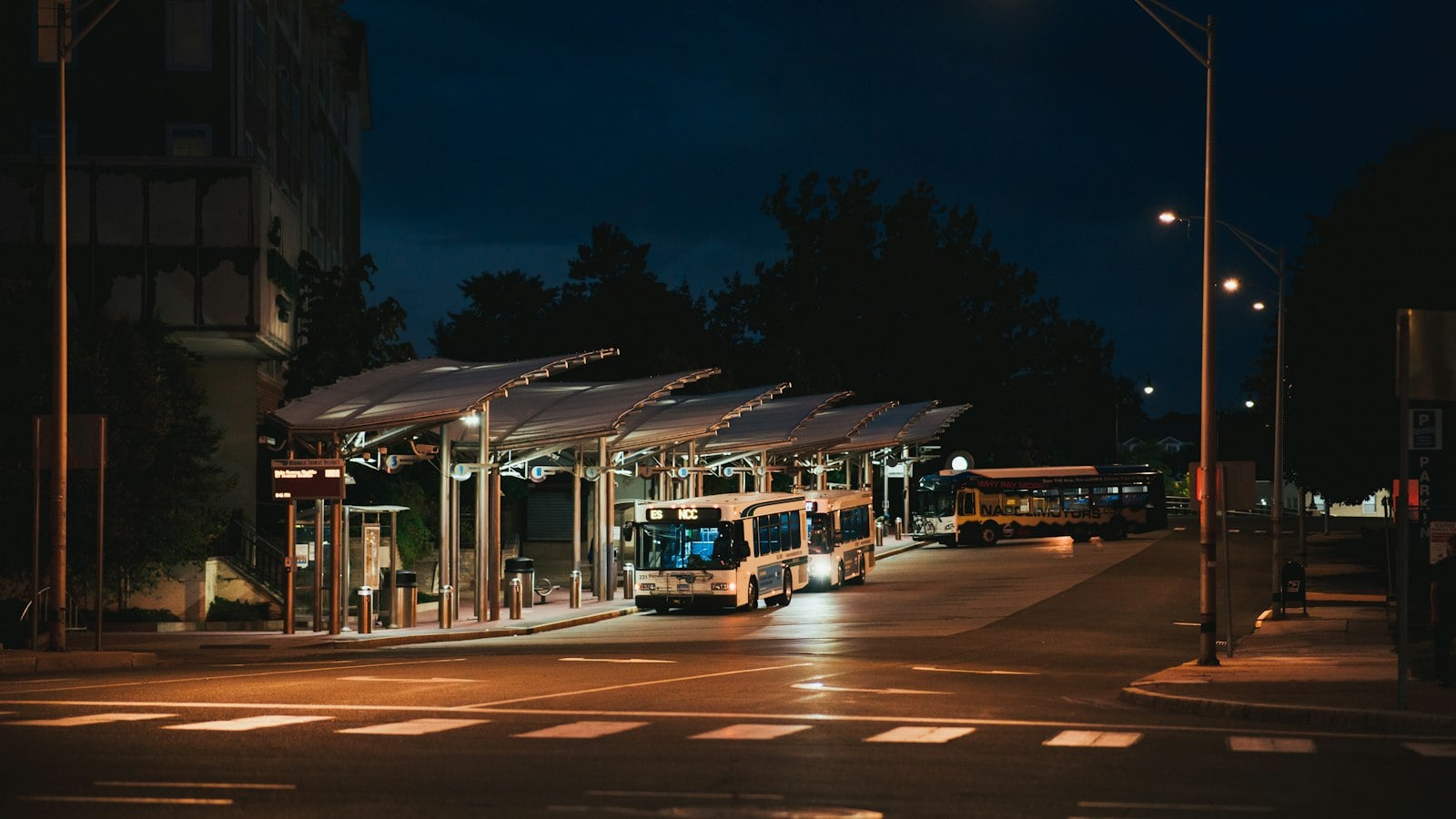 Covered bus departure bays at night (photo: Nicholas Bartos / Unsplash)