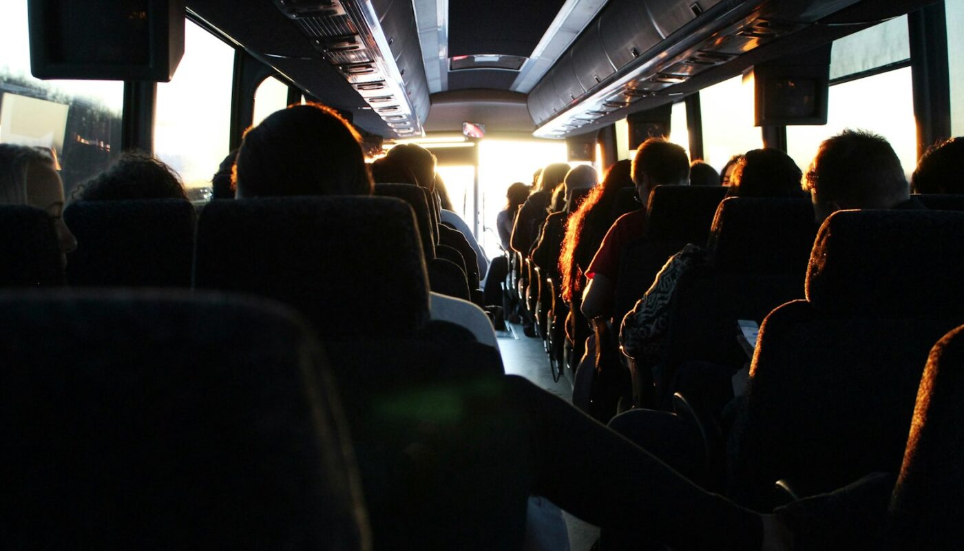 Passengers seated inside a long-distance coach (photo: Ash Gerlach / Unsplash)