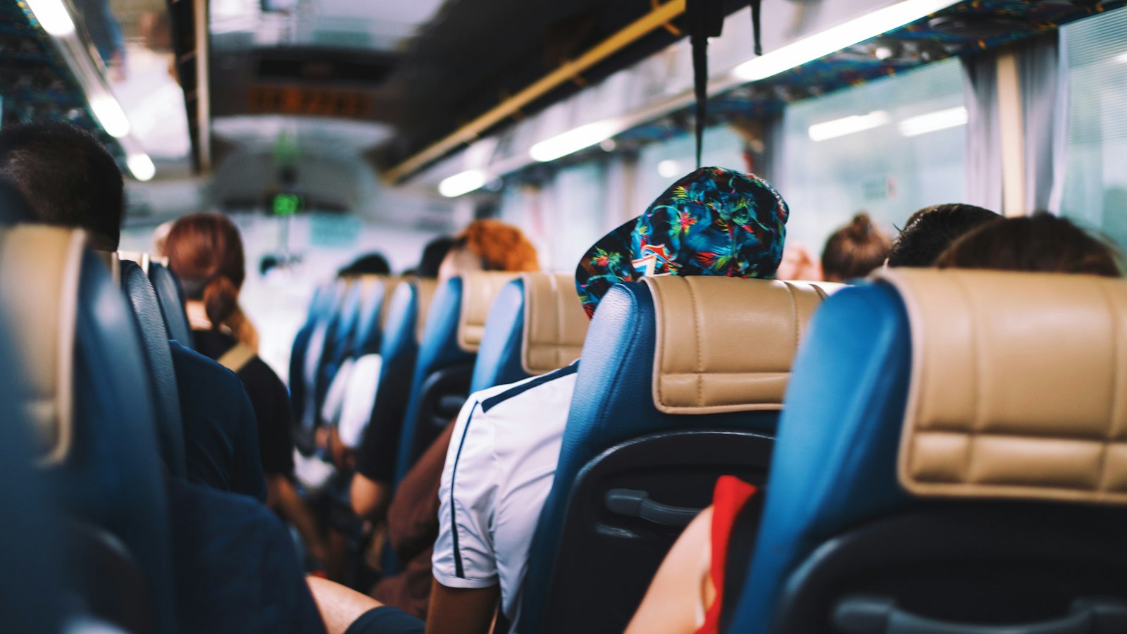 Travellers settled into coach seats on a long journey (photo: Annie Spratt / Unsplash)