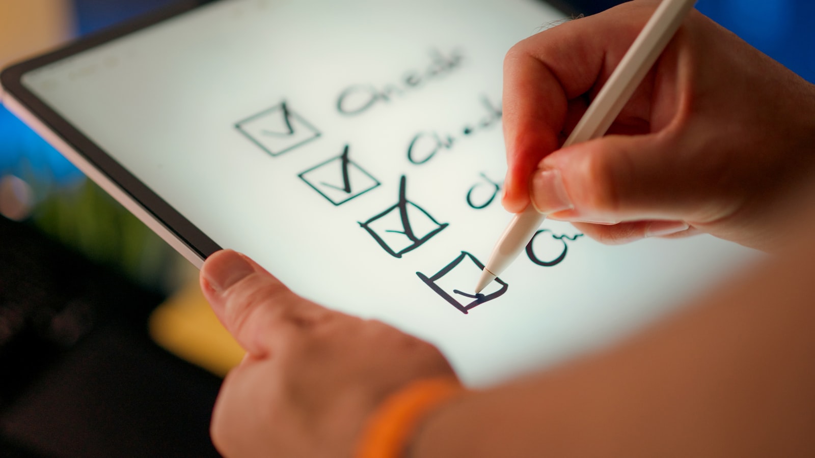 A hand ticking items off a printed checklist (photo: Jakub Zerdzicki / Unsplash)