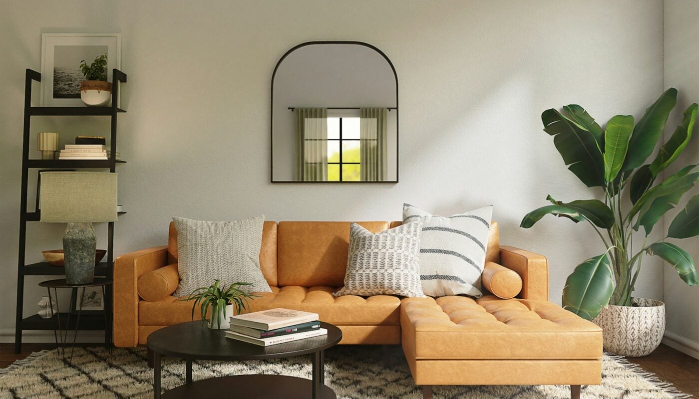 Living room with a patterned area rug under a sofa and coffee table (photo: Spacejoy / Unsplash)