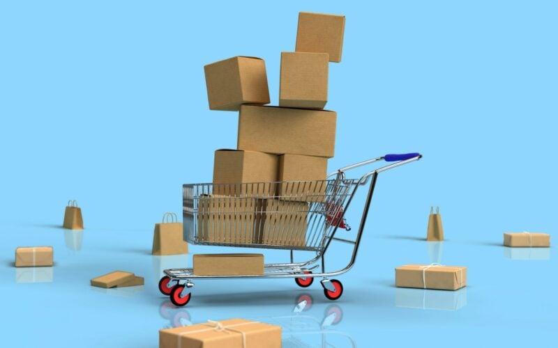 Miniature shopping trolley overflowing with cardboard parcels (photo: Shutter Speed / Unsplash)