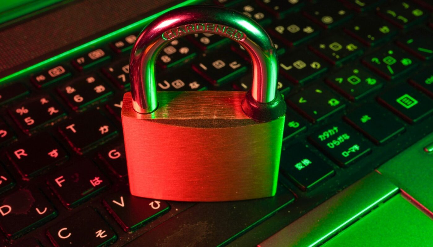 Red padlock resting on a black computer keyboard (photo: FlyD / Unsplash)