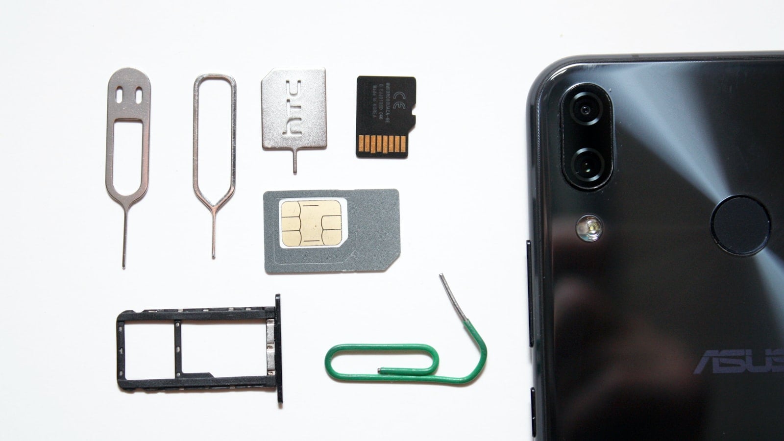 A SIM card being fitted into the tray of a mobile phone (photo: Andrey Matveev / Unsplash)
