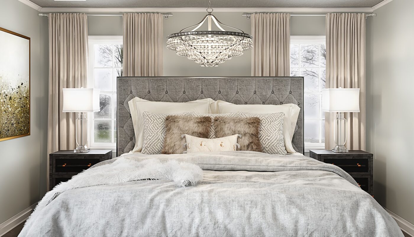 A large made bed in a warmly styled bedroom with bedside lamps and layered bedding (photo: Spacejoy / Unsplash)
