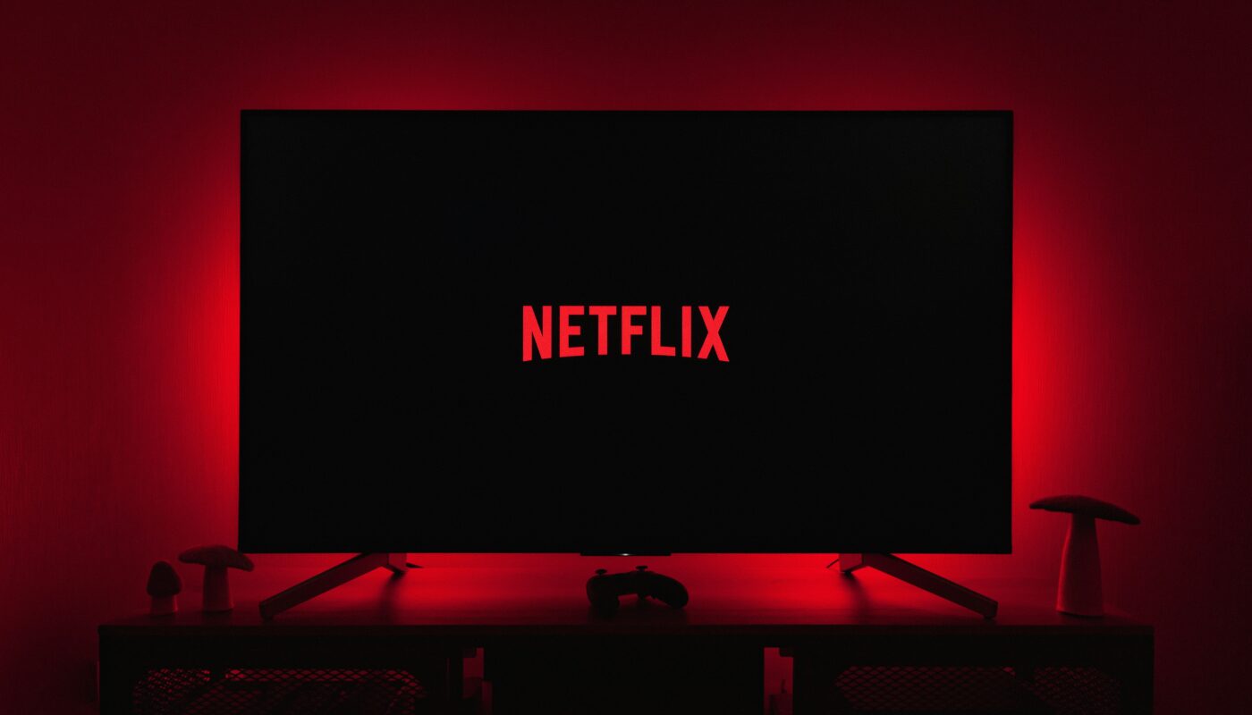 Netflix logo on a television screen with red ambient lighting behind it