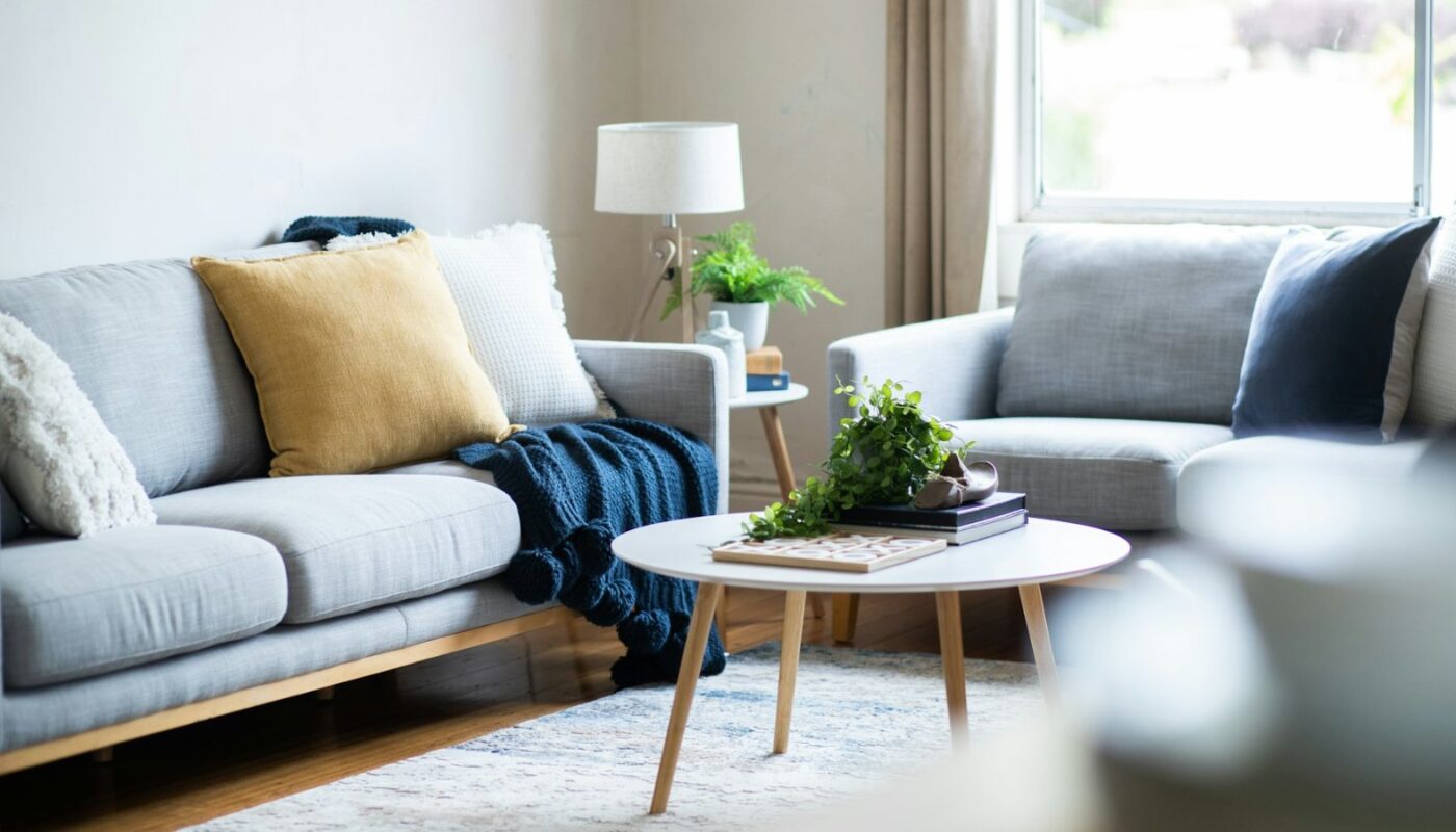 Tidy living room with a sofa and a low coffee table (photo: S.Group Official / Unsplash)