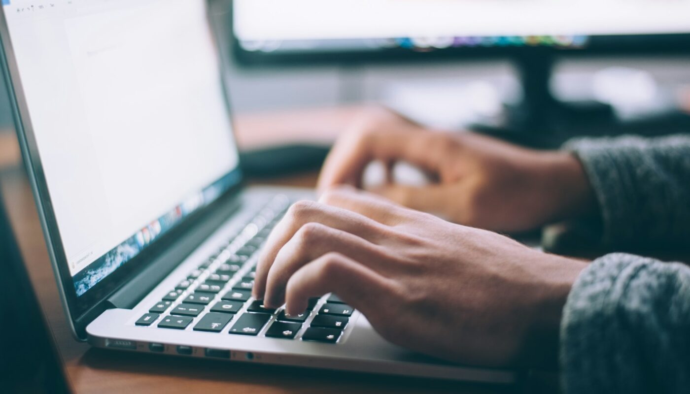 Hands typing on a laptop keyboard (photo: Glenn Carstens-Peters / Unsplash)