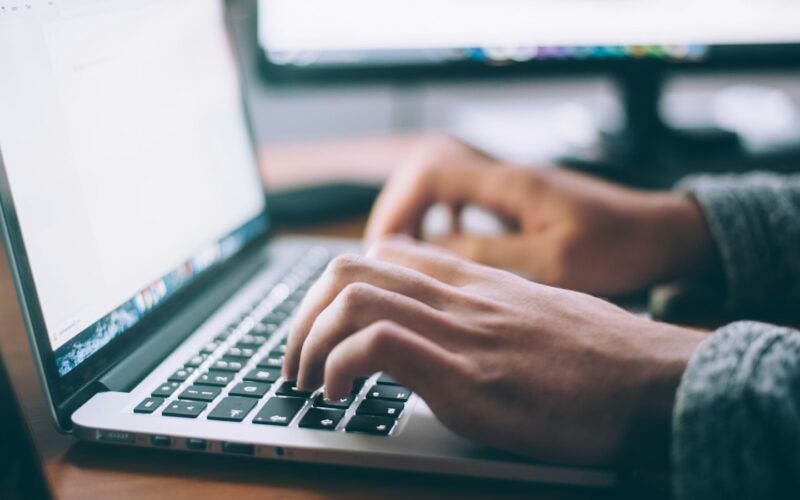 Hands typing on a laptop keyboard (photo: Glenn Carstens-Peters / Unsplash)