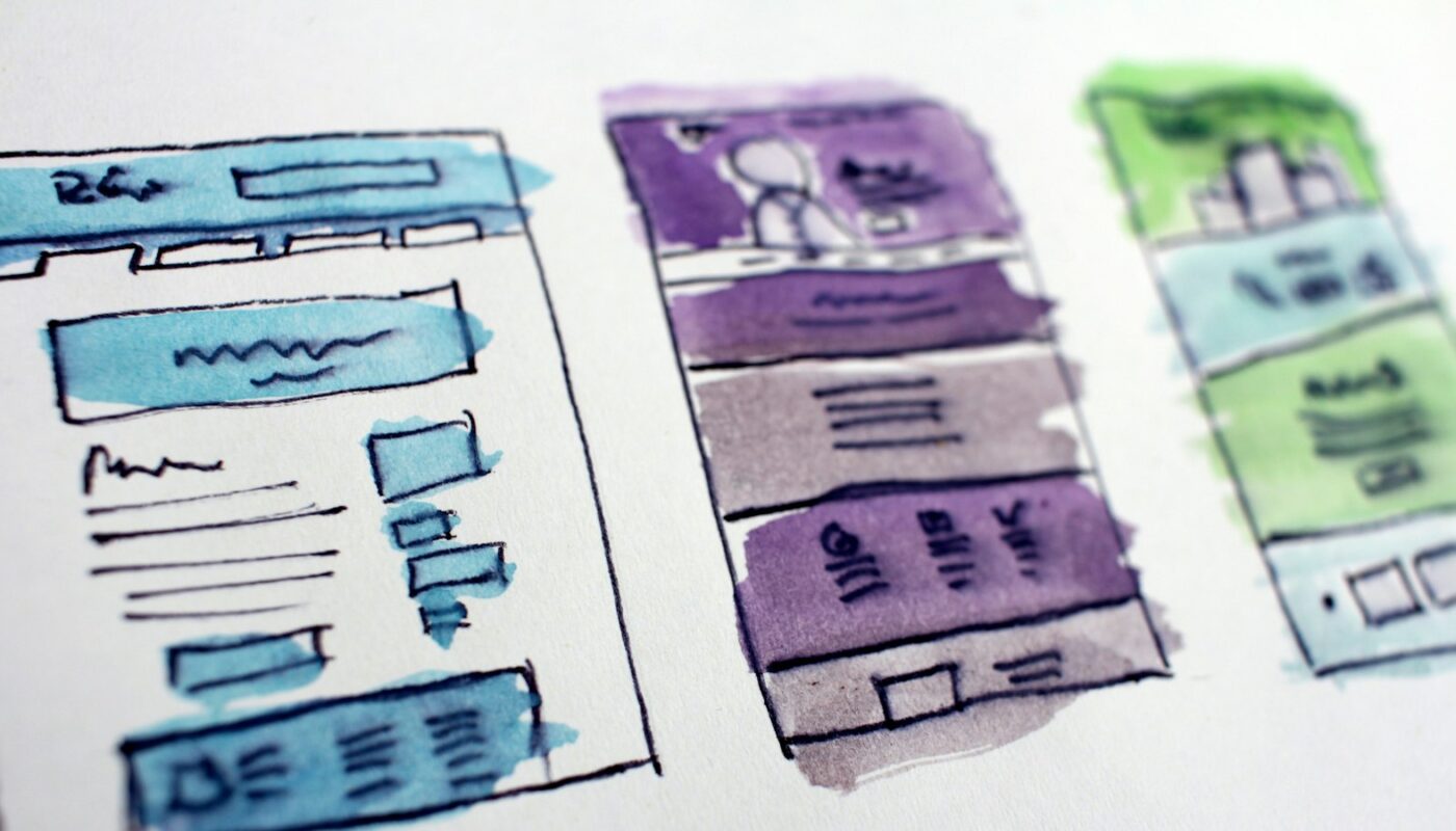 Hand-drawn website layout sketches washed in blue, purple and green watercolour (photo: Hal Gatewood / Unsplash)