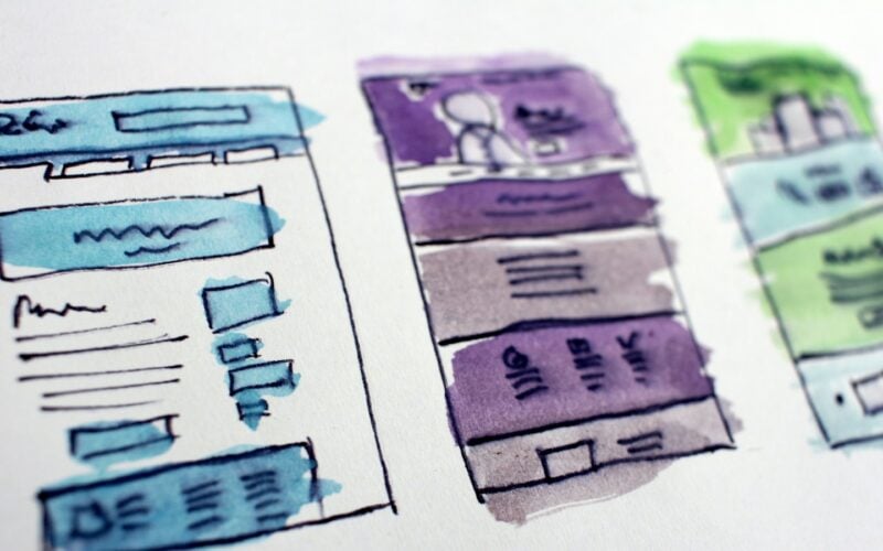 Hand-drawn website layout sketches washed in blue, purple and green watercolour (photo: Hal Gatewood / Unsplash)